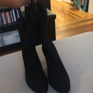 Black cloth ankle boot by Carlos Santana.